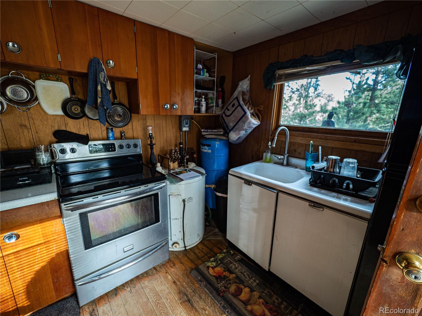 470 Mesa Drive Evergreen, CO 80439 - Photo 25 of 28 a kitchen with a stove and a microwave