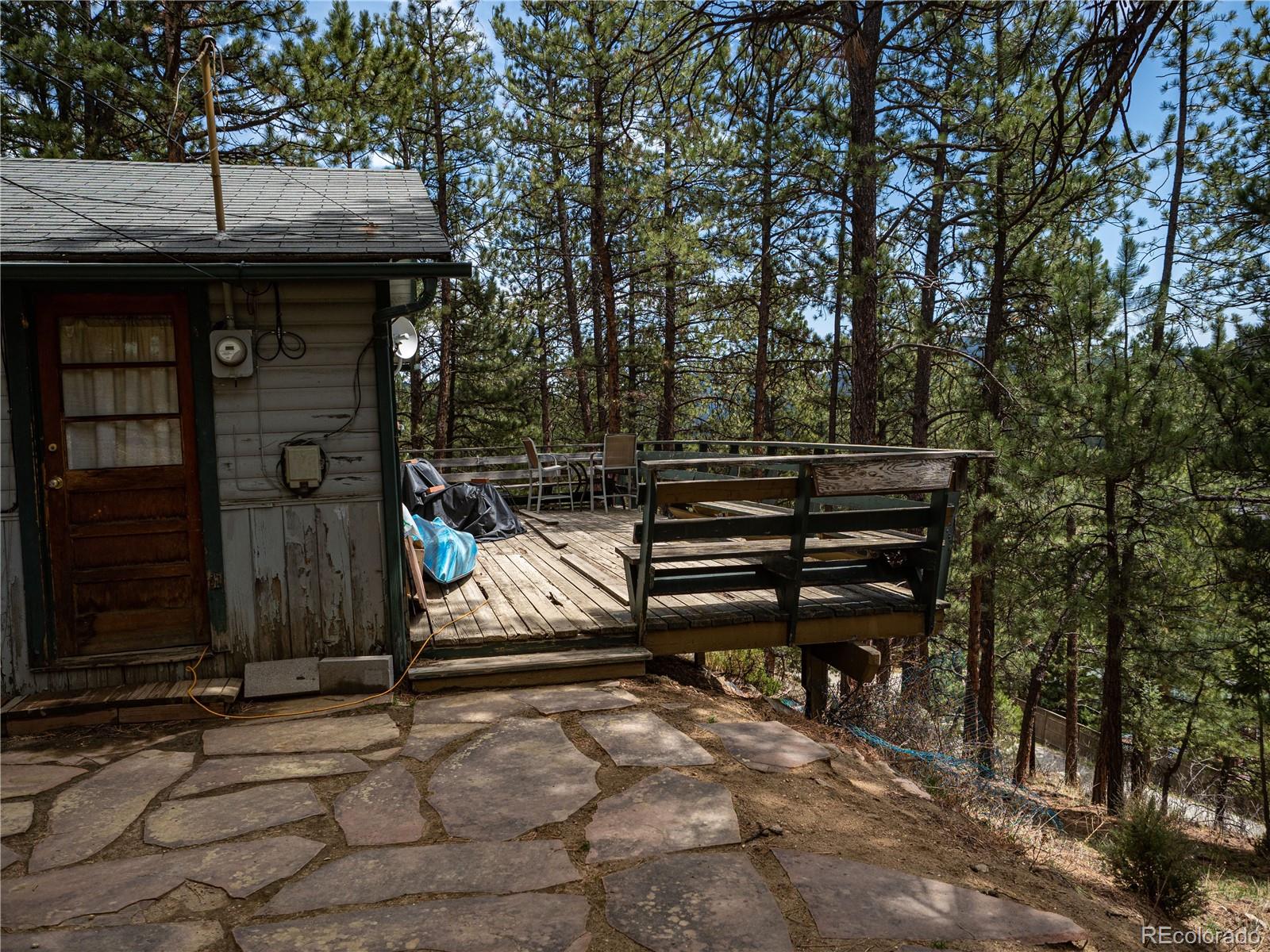 470 Mesa Drive Evergreen, CO 80439 - Photo 6 of 28 a backyard of a house with barbeque oven and trees