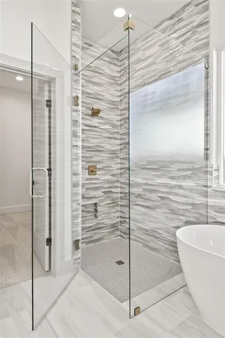 a bathroom with a bathtub and a shower