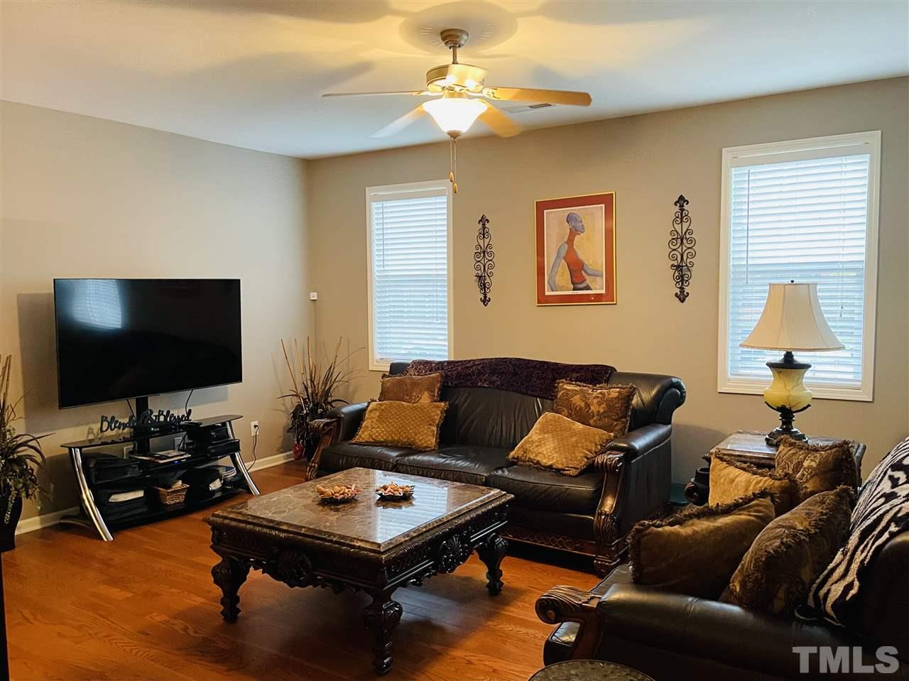 1368 Regulator Street Raleigh, NC 27603 - Photo 4 of 18 a living room with furniture and a flat screen tv