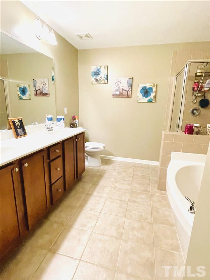 1368 Regulator Street Raleigh, NC 27603 - Photo 10 of 18 a bathroom with a sink mirror vanity and toilet