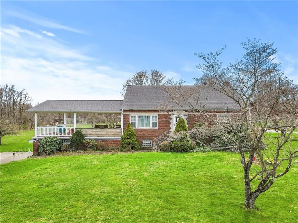 123 Buttercup Road Butler, PA 16001 - Photo 1 of 25 a view of a house with a yard and a garden