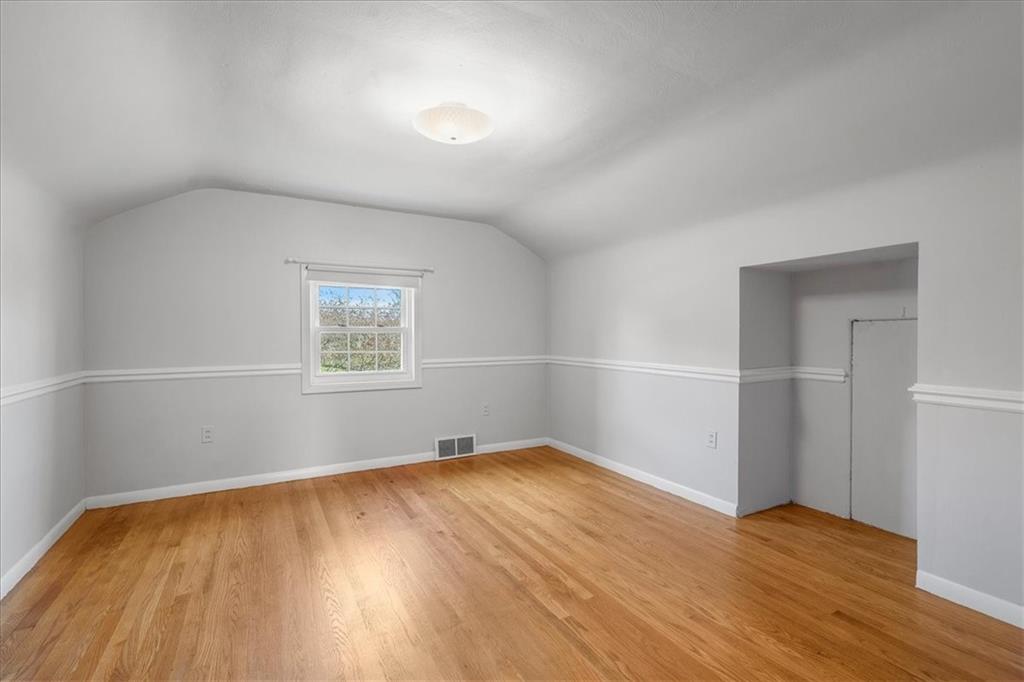 123 Buttercup Road Butler, PA 16001 - Photo 14 of 25 an empty room with wooden floor and windows