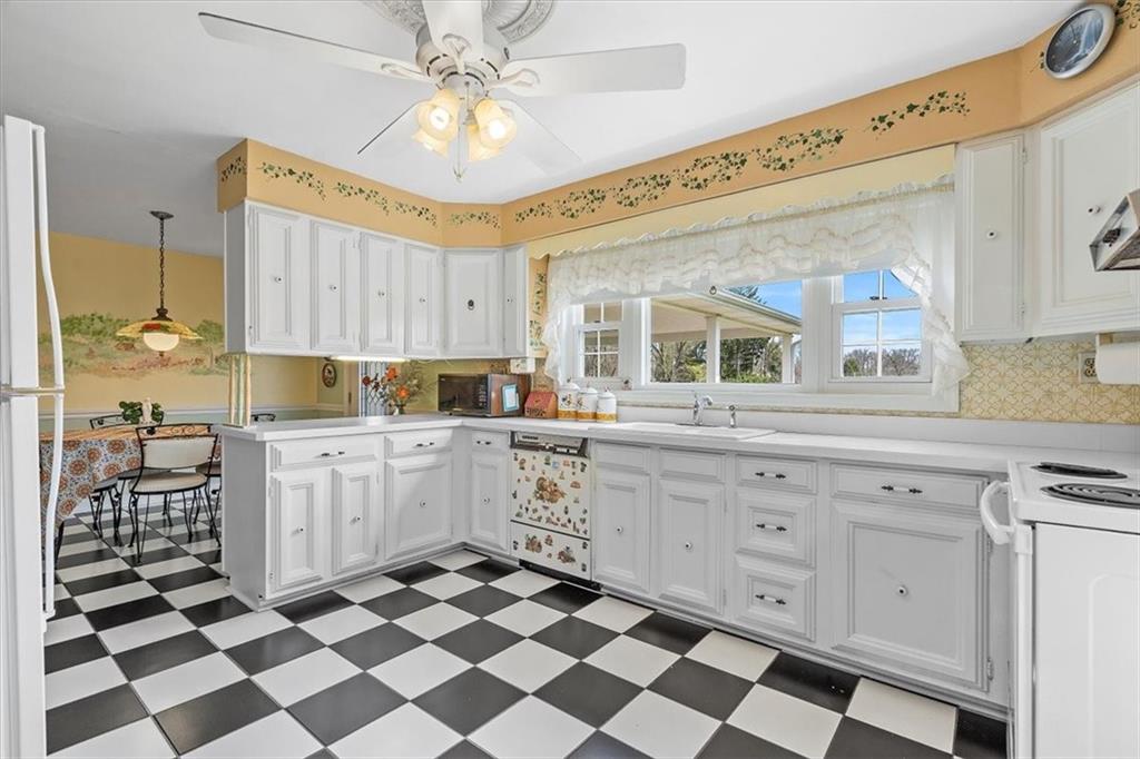 123 Buttercup Road Butler, PA 16001 - Photo 5 of 25 a kitchen with a checkered floor and white cabinets