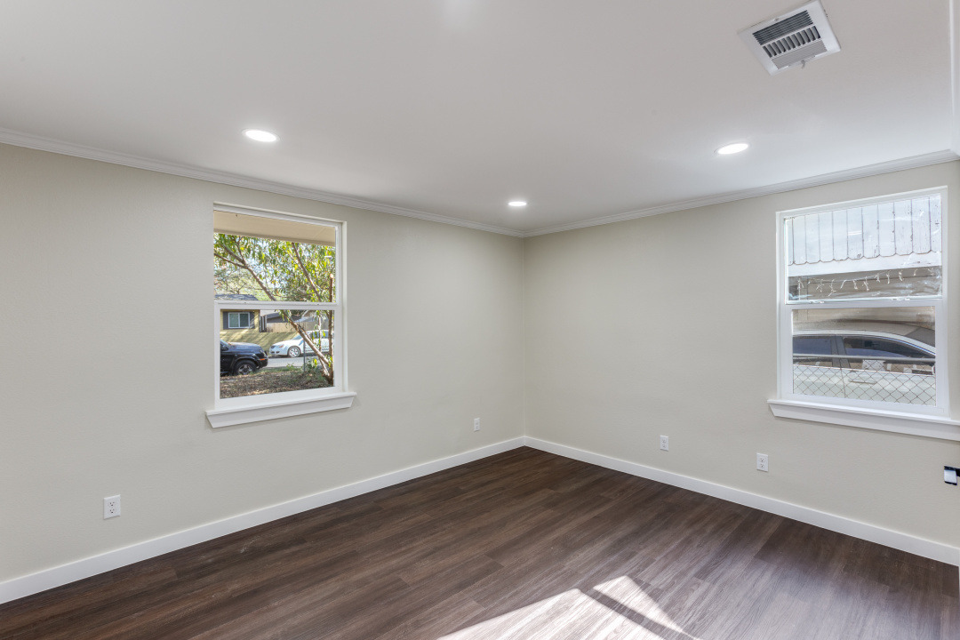 1118 Spur Street Austin, TX 78721 - Photo 15 of 27 Unfurnished room featuring dark wood finished floors, recessed lighting, and crown molding