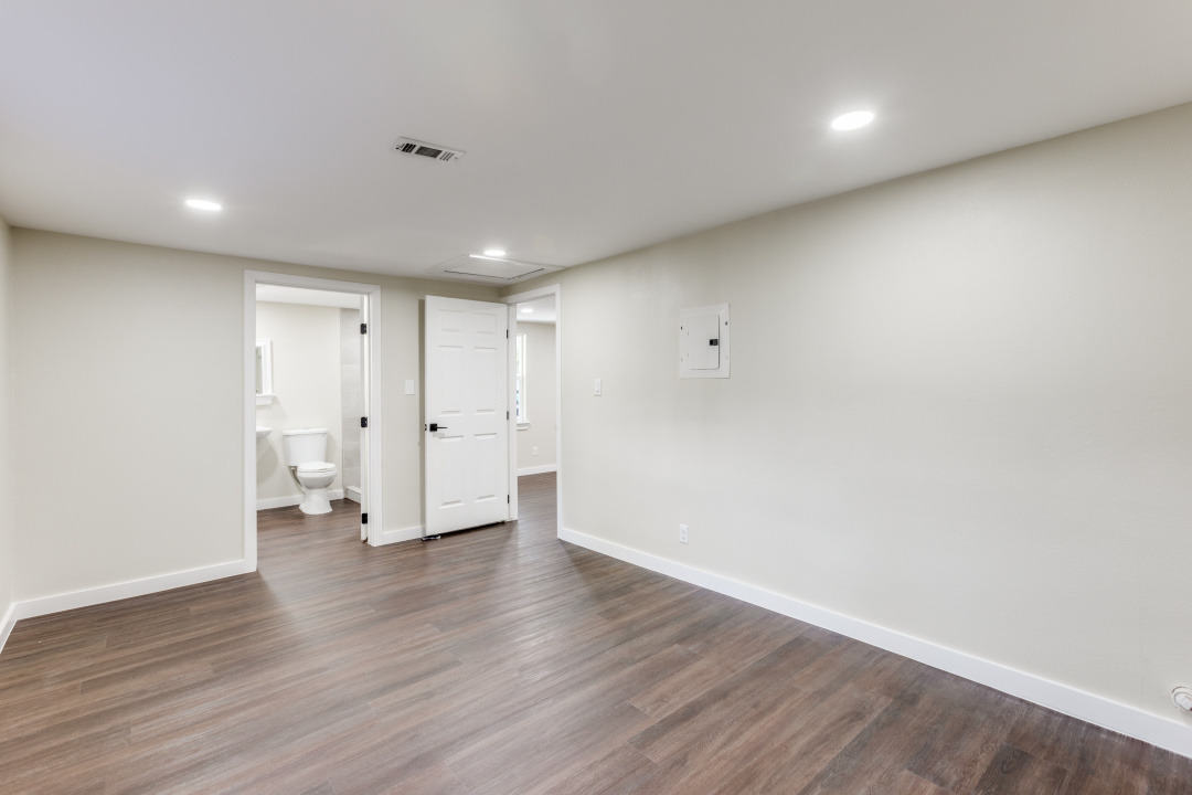1118 Spur Street Austin, TX 78721 - Photo 18 of 27 Spare room featuring attic access, dark wood-type flooring, and recessed lighting