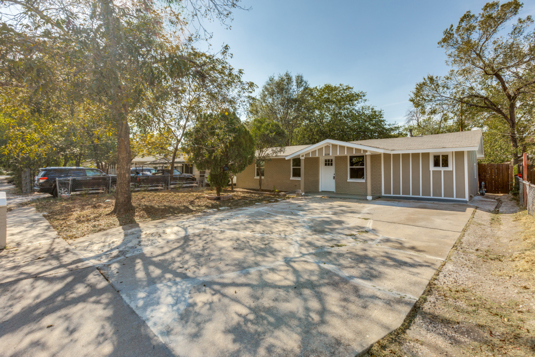 1118 Spur Street Austin, TX 78721 - Photo 2 of 27 Single story home featuring driveway, brick siding, and covered porch