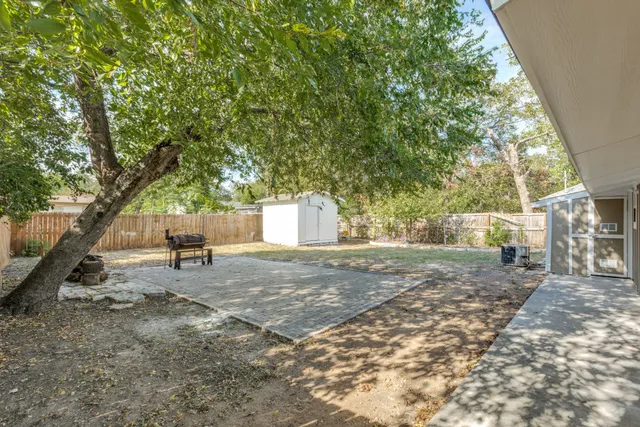 a backyard of a house with table and chairs
