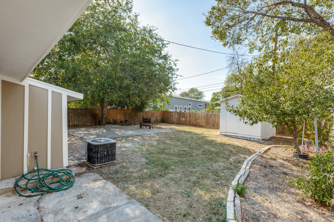1118 Spur Street Austin, TX 78721 - Photo 27 of 27 Fenced backyard with a patio area and a shed