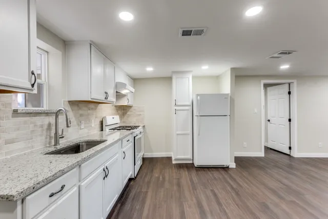 a kitchen with a sink stainless steel appliances and cabinets