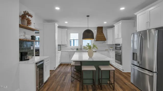 a kitchen with granite countertop a sink a stove and cabinets