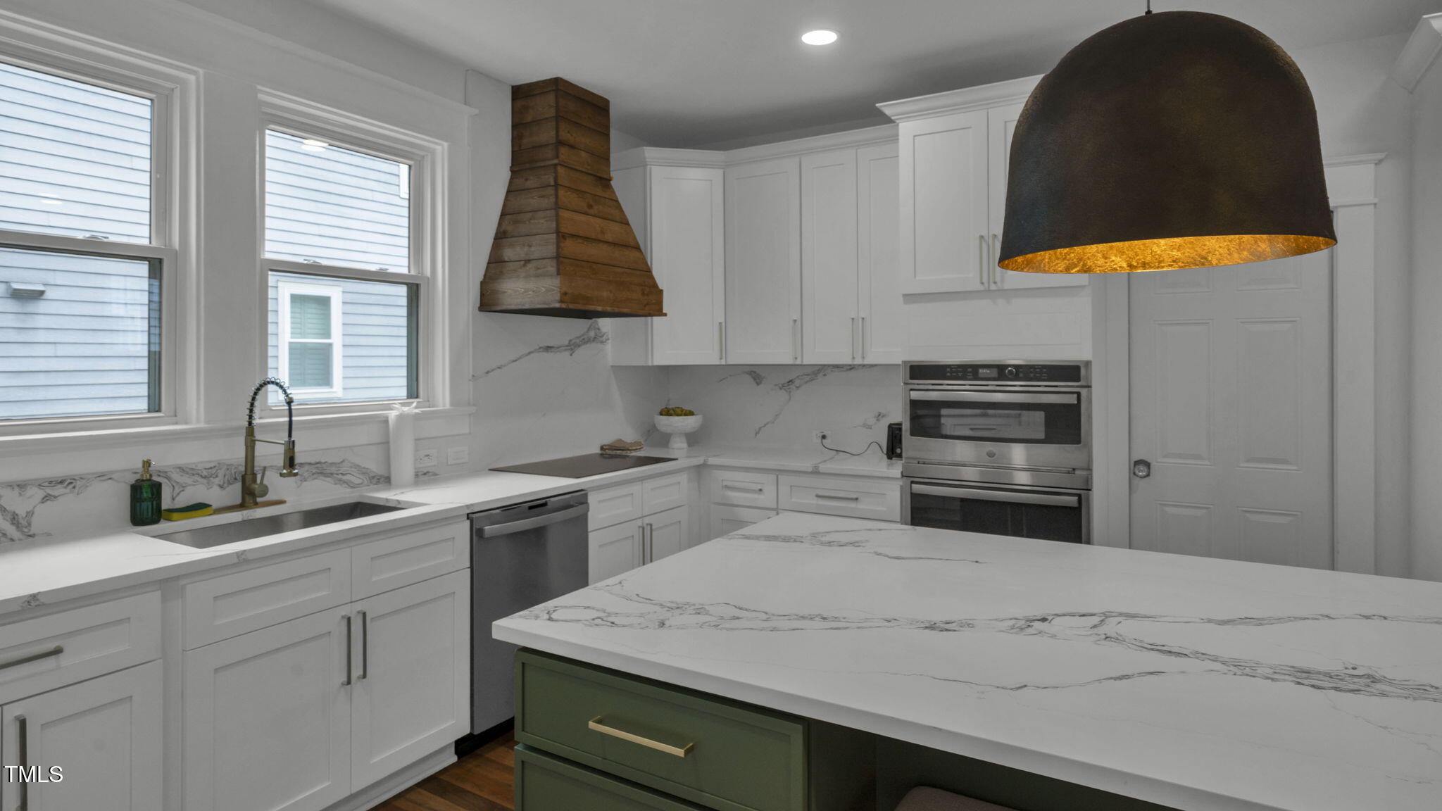 1307 Wake Forest Road Raleigh, NC 27604 - Photo 24 of 52 a kitchen with a sink a stove and a cabinets