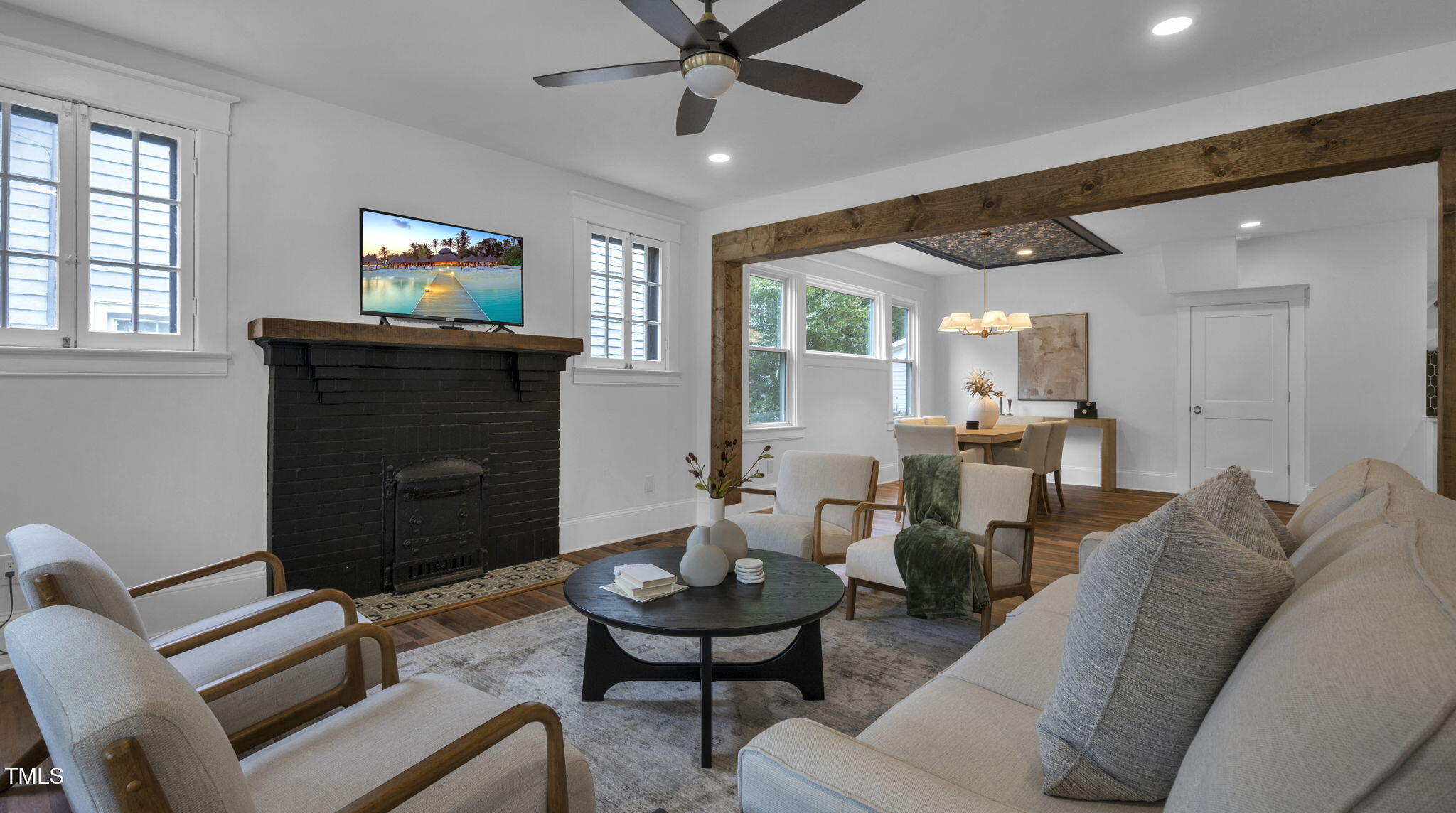 1307 Wake Forest Road Raleigh, NC 27604 - Photo 28 of 52 a living room with furniture a chandelier and a fireplace