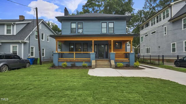 a view of a house with a yard and sitting area