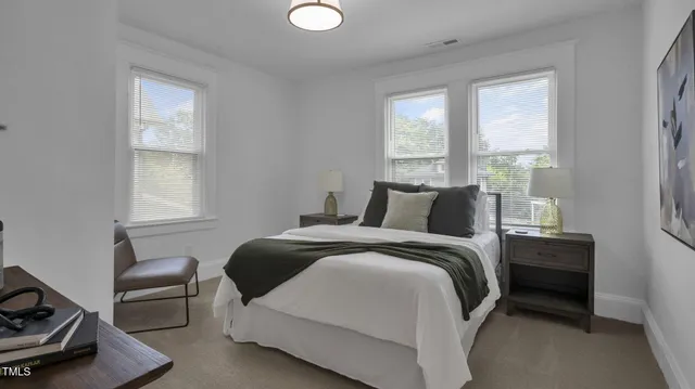 a bedroom with two beds and a window