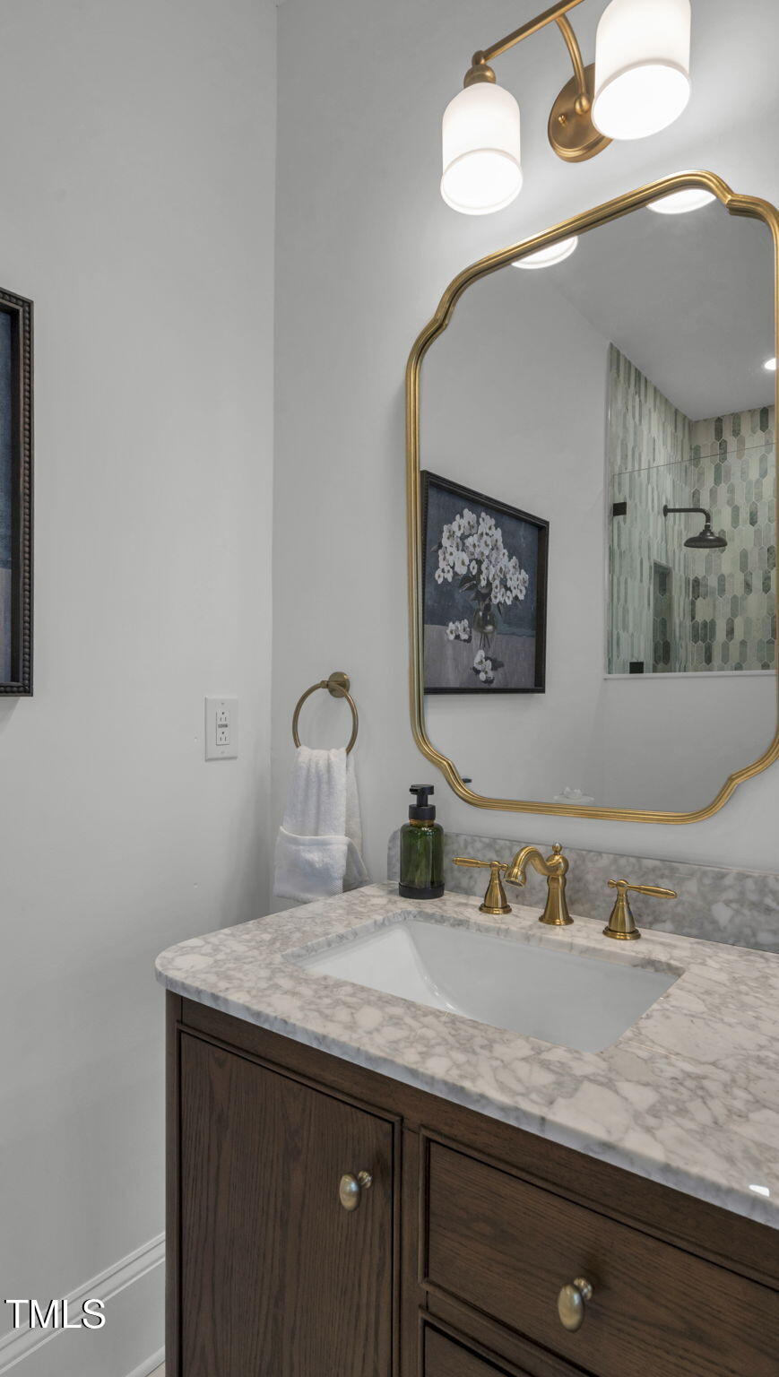 1307 Wake Forest Road Raleigh, NC 27604 - Photo 46 of 52 a bathroom with a granite countertop sink and a mirror