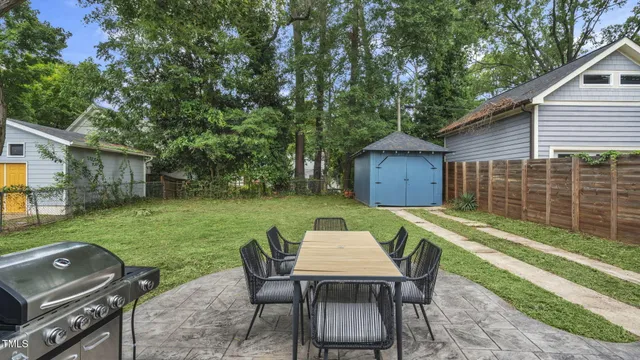 a view of a backyard with table and chairs and a small yard