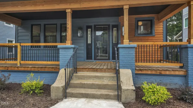 a view of a house with a large window and wooden floor