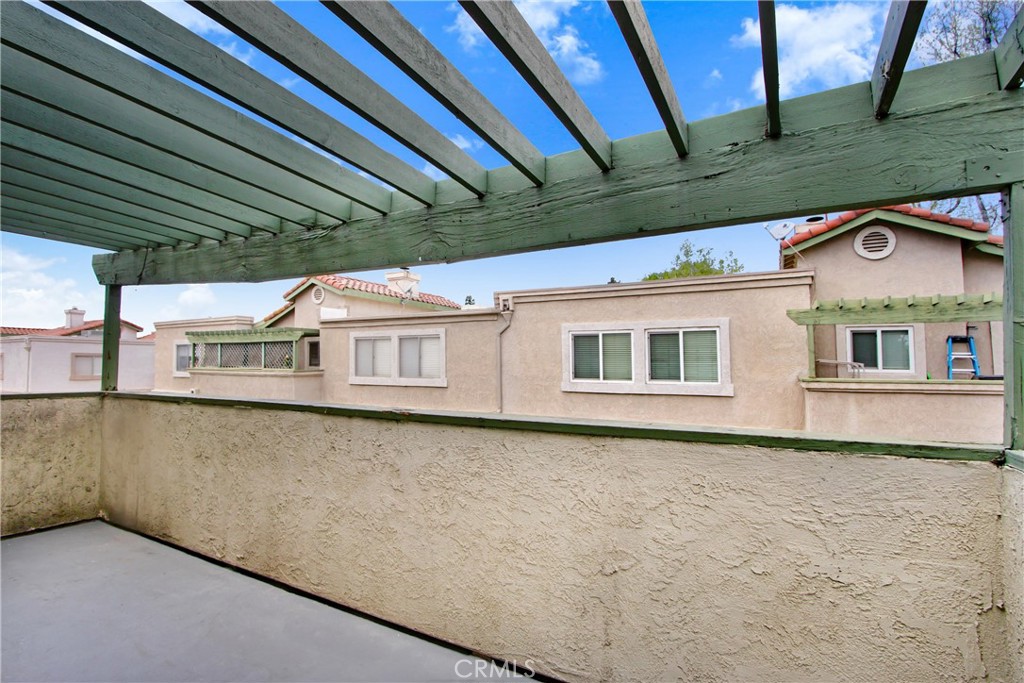 8353 Sunset Trail Place, Unit E Rancho Cucamonga, CA 91730 - Photo 14 of 18 a front view of a house with a yard