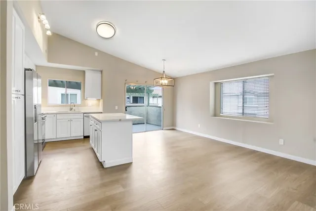 a view of a kitchen with wooden floor and windows