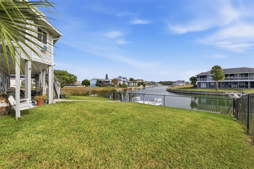 3366 Bluefish Drive Hernando Beach, FL 34607 - Photo 31 of 75 a swimming pool with outdoor seating and yard