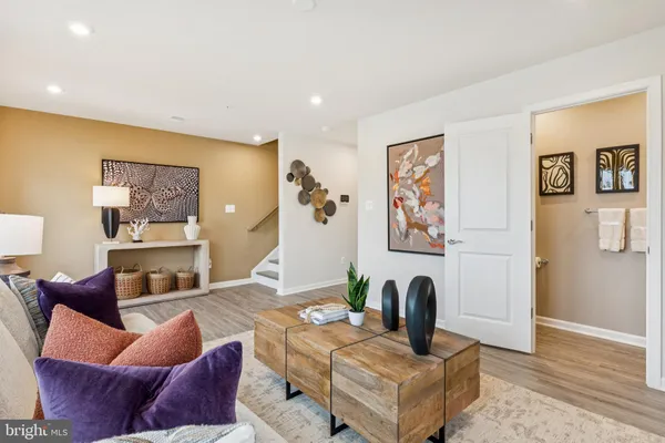 a living room with furniture and a wooden floor