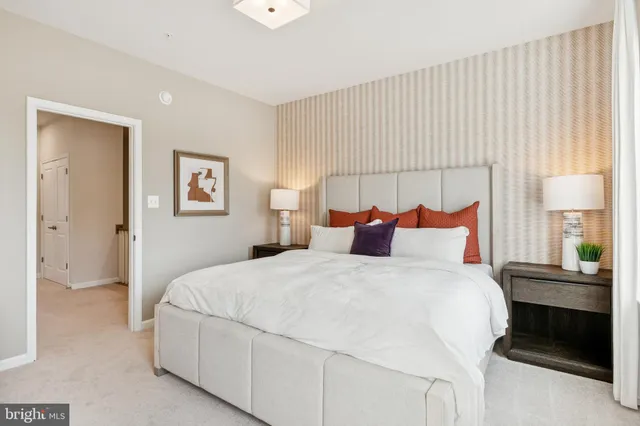 a bedroom with a bed and a lamp