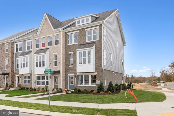 a front view of a residential apartment building with a yard