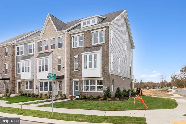 a front view of a residential apartment building with a yard