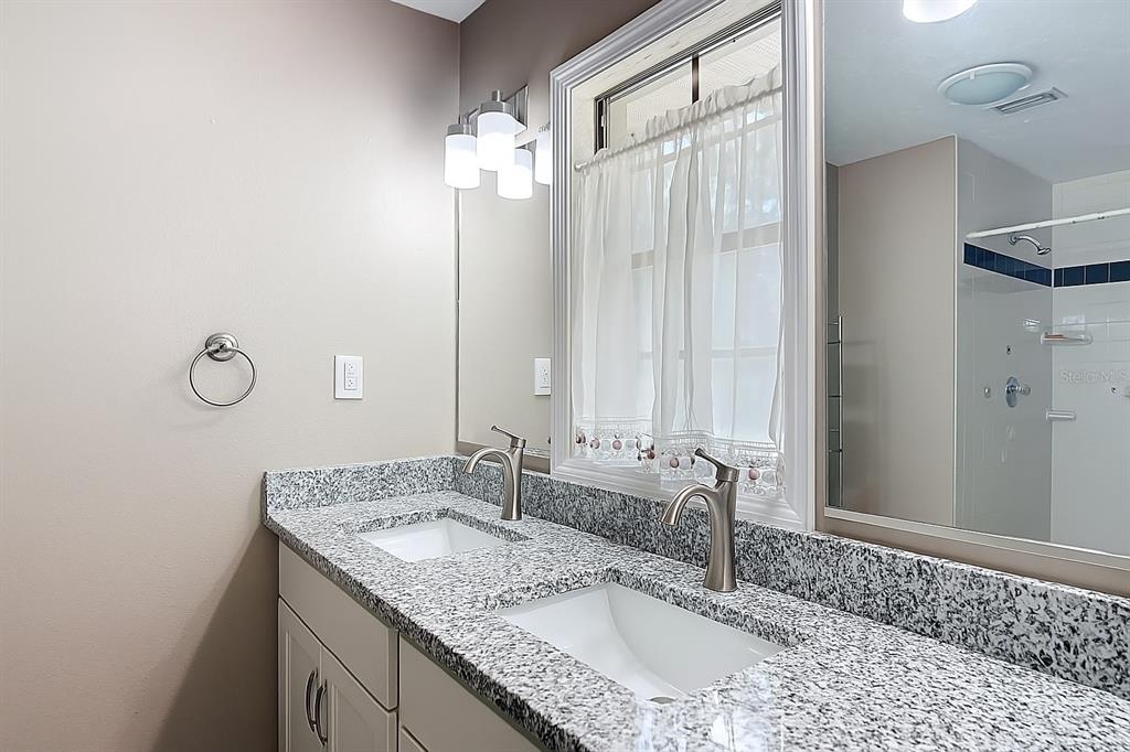 45 Forest Lane Bronson, FL 32621 - Photo 12 of 22 a bathroom with a granite countertop sink and a mirror