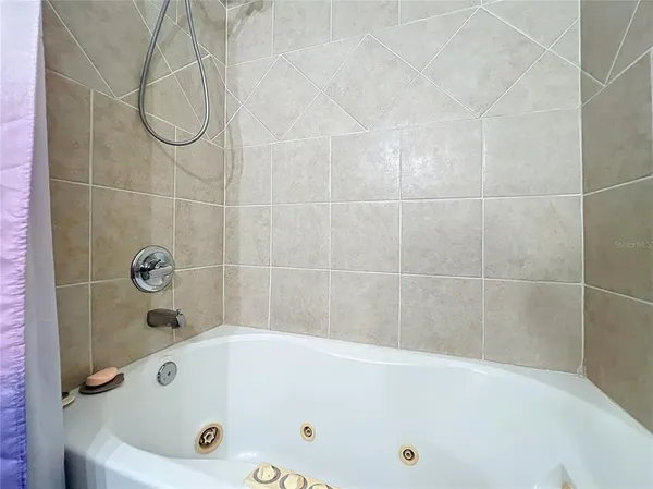 a bathroom with a tub and a shower