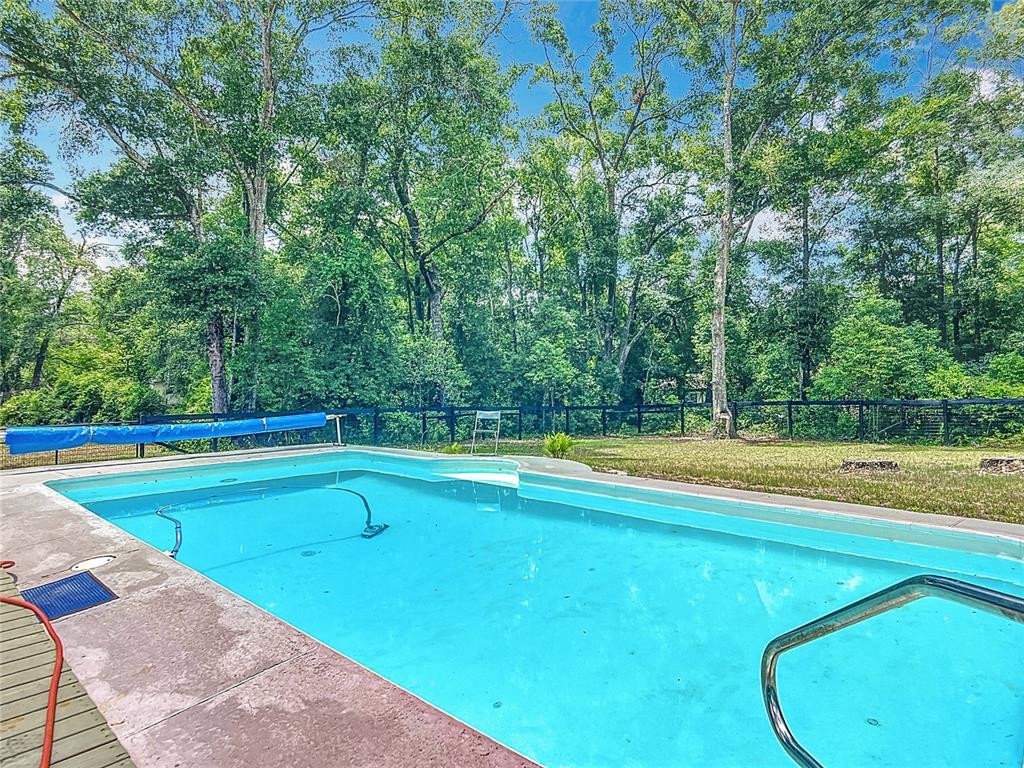 45 Forest Lane Bronson, FL 32621 - Photo 16 of 22 a view of a swimming pool with a yard