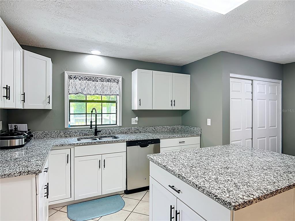 45 Forest Lane Bronson, FL 32621 - Photo 7 of 22 a kitchen with stainless steel appliances granite countertop a sink stove and cabinets