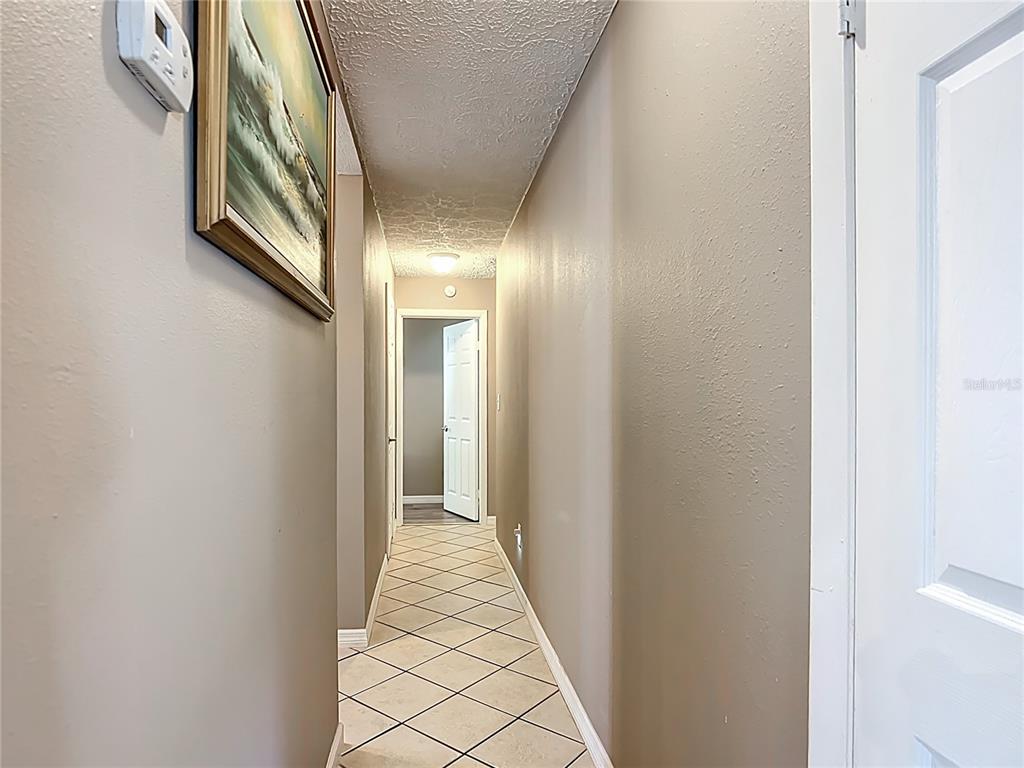 45 Forest Lane Bronson, FL 32621 - Photo 9 of 22 a view of a hallway with wooden floor