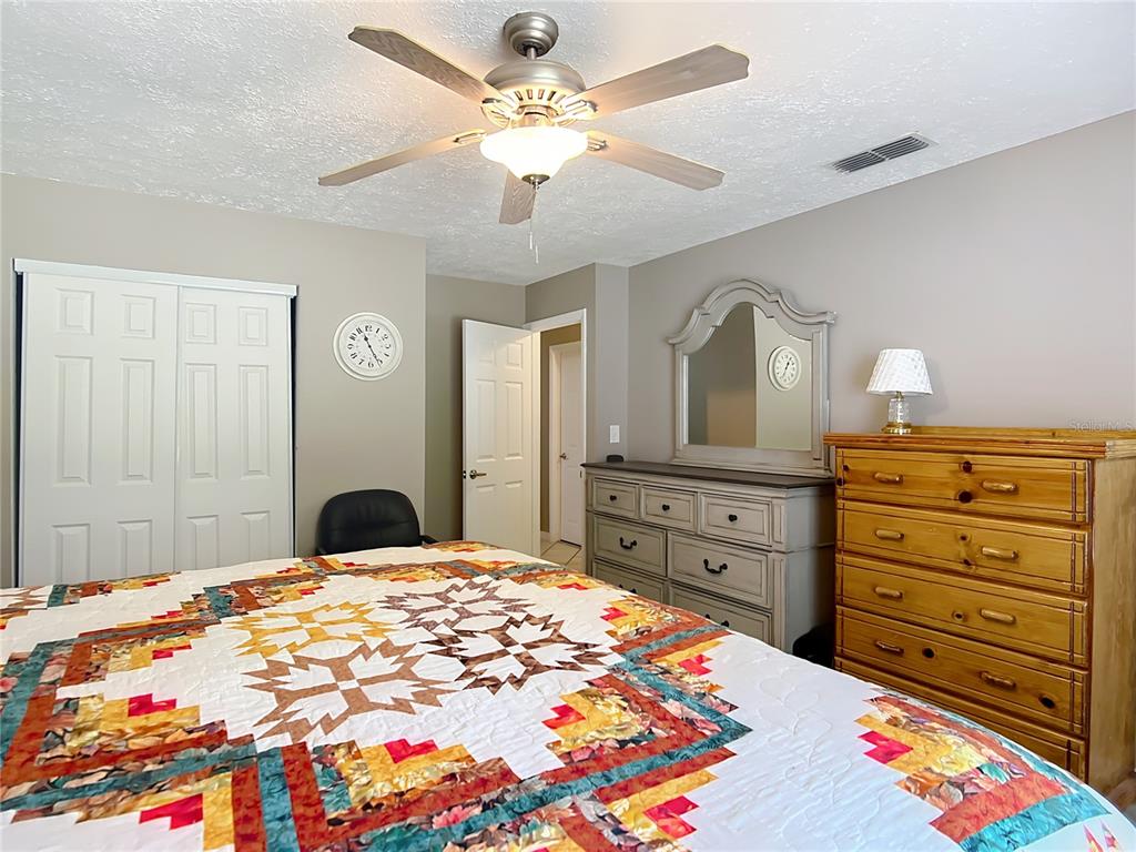 45 Forest Lane Bronson, FL 32621 - Photo 10 of 22 a bedroom with a bed and a dresser