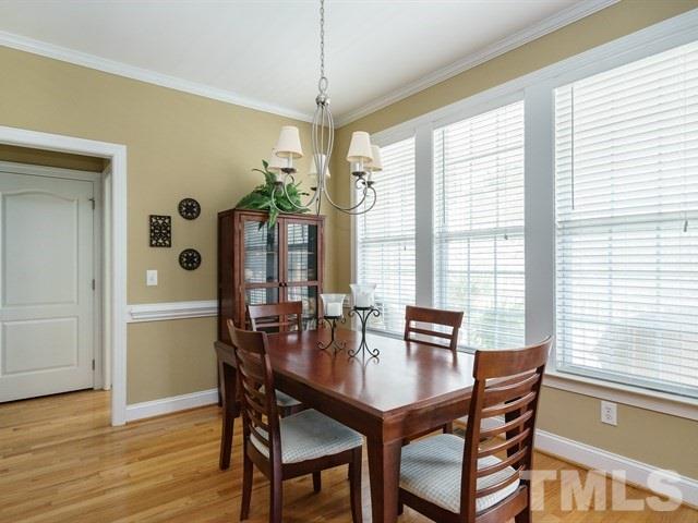 1729 Shell Cracker Drive Willow Spring, NC 27592 - Photo 8 of 22 a view of a dining room with furniture window and wooden floor