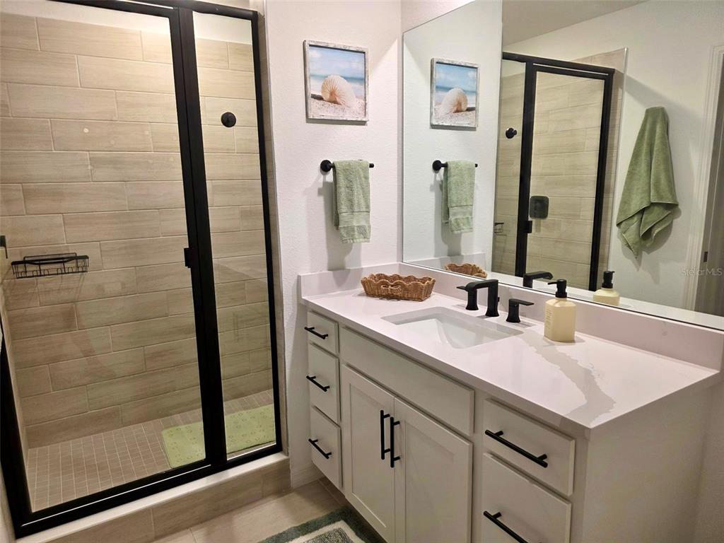 19116 Scallop Loop, Unit 303 Lakewood Ranch, FL 34211 - Photo 6 of 32 a bathroom with a sink and a mirror