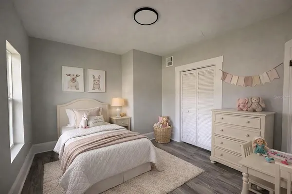 a bedroom with a bed and with furniture