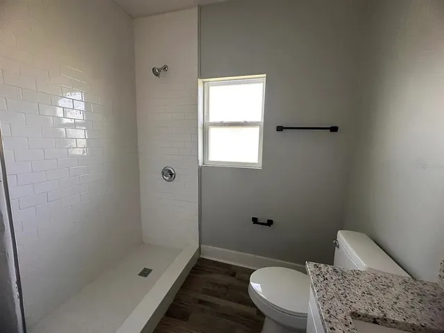 a bathroom with a toilet and shower