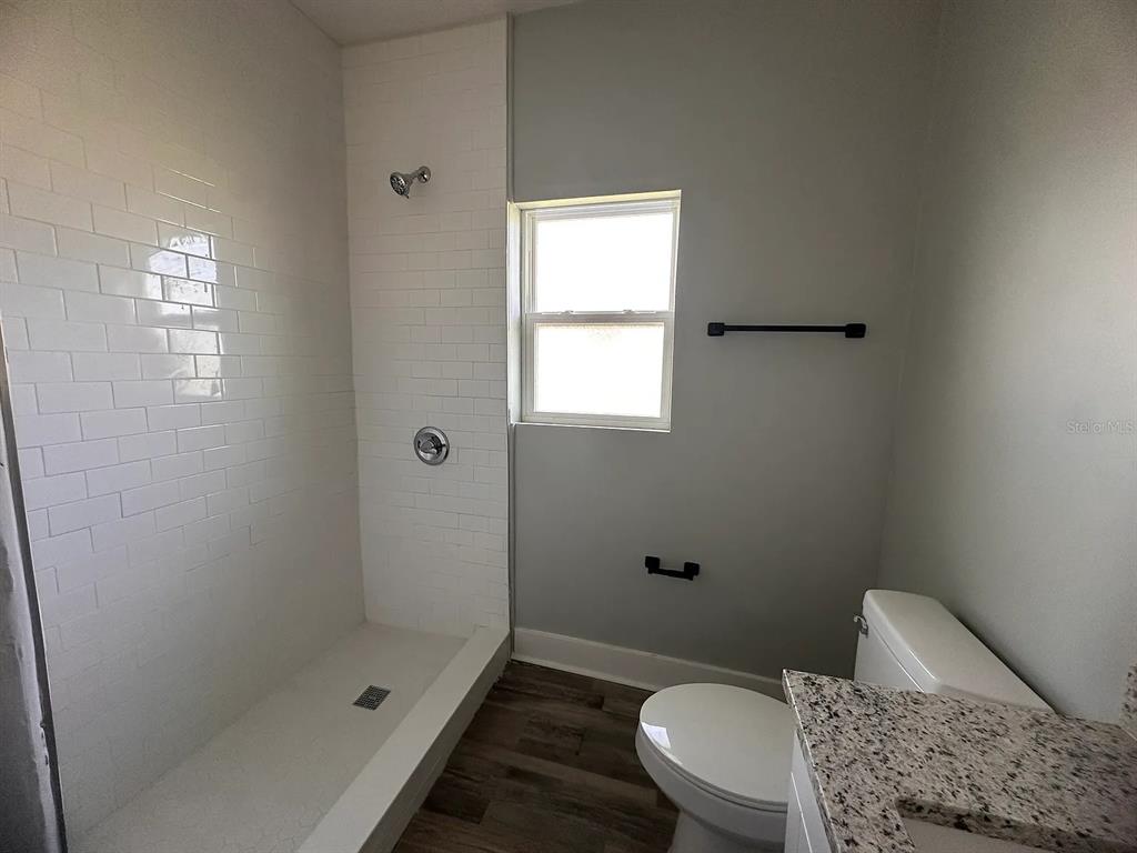 107 Ave F Southwest Winter Haven, FL 33880 - Photo 12 of 21 a bathroom with a toilet and shower