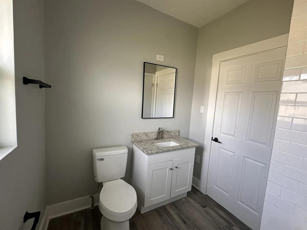 107 Ave F Southwest Winter Haven, FL 33880 - Photo 13 of 21 a bathroom with a toilet sink and mirror