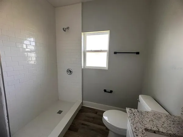 a bathroom with a toilet and shower