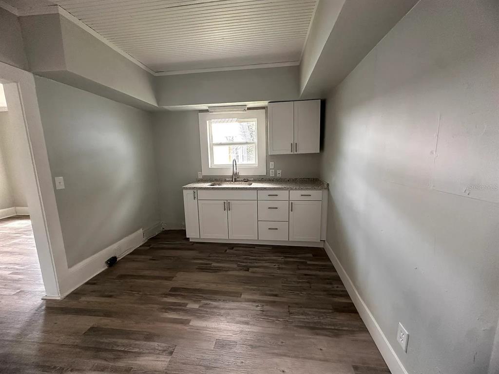 107 Ave F Southwest Winter Haven, FL 33880 - Photo 16 of 21 a kitchen with sink cabinets and wooden floor