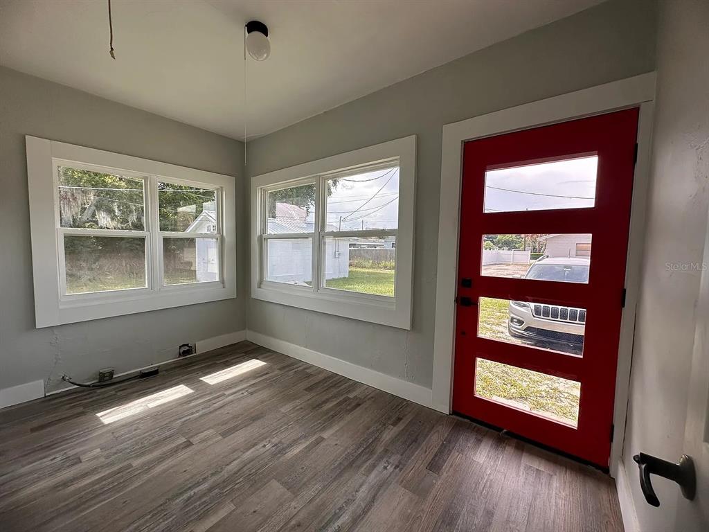 107 Ave F Southwest Winter Haven, FL 33880 - Photo 18 of 21 a view of an empty room with wooden floor and a window