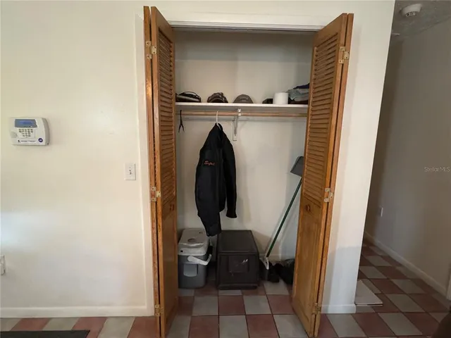 a kitchen with stainless steel appliances granite countertop a refrigerator a sink a stove a washer dryer and a refrigerator