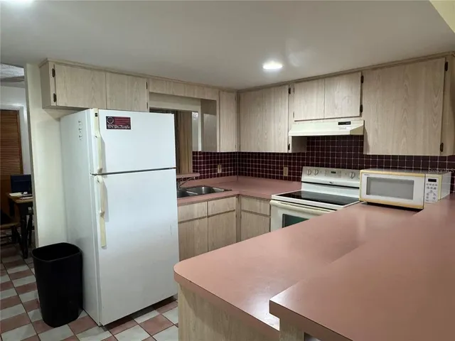 a living room with a flat screen tv and chandelier