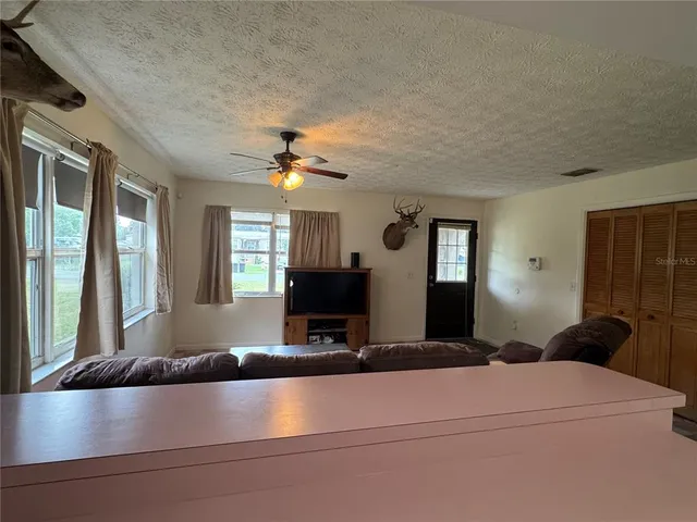 a dining room with furniture and window