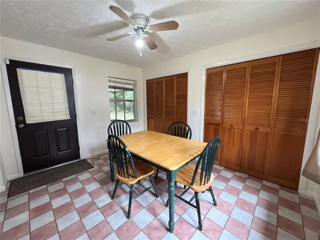 a view of a dining room with furniture and window