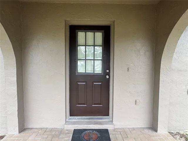 a house that has a large tree in front of it