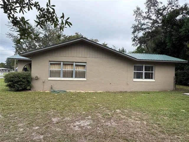 a house with trees in the background